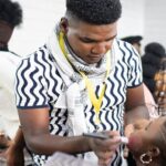 Image of Lloyd Thabede applying make-up on a client