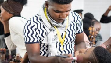 Image of Lloyd Thabede applying make-up on a client